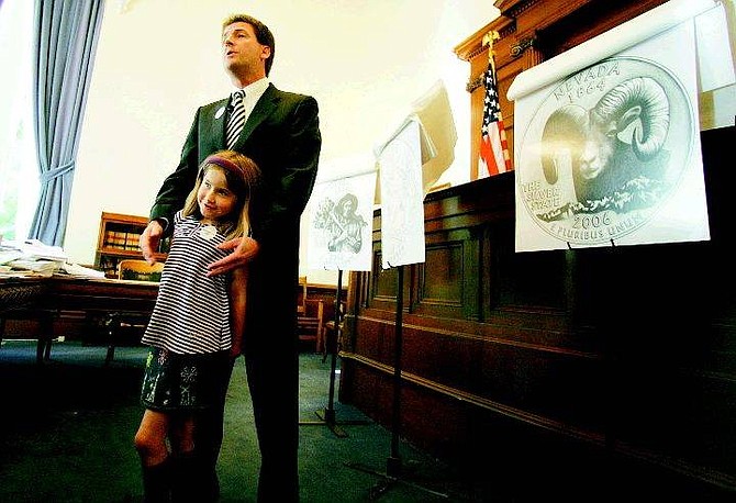 BRAD HORN/NEVADA APPEAL Nevada State Treasurer Brian Krolicki answers questions with his daughter Kate, 6, a first-grade student at Zephyr Cove Elementary school.