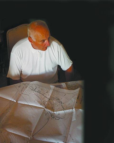 Rick Gunn/Nevada Appeal Tom Snodgrass, chairman of the Dayton Valley Events Board, sits with a set of plans Tuesday in Dayton. The plans included the proposed motocross track and equestrian center, which would be added to the existing fairgrounds in Dayton.