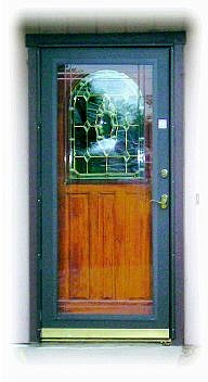 An all-glass storm door allows guests to see the beauty of the real door.