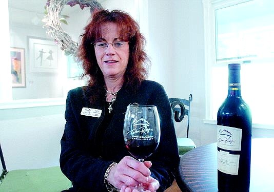 Rick Gunn/Nevada Appeal Kathy Halbardier holds a glass of zinfandel at the Tahoe Ridge Winery &amp; Marketplace in Genoa. She founded the Genoa-based winery with her husband, Rick, and Roger and Gail Teig of the Van Sickle Station Ranch.