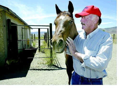 Larry McPherson talks to his horse, Sundown, on Monday at his Stagecoach ranch. McPherson, president of the Nevada Division of the National Pony Express Association will ride in the 27th annual Pony Express Reride.    Cathleen Allison Nevada Appeal