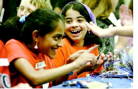 Cathleen Allison/Nevada Appeal Aishwarya Krishnamoorthy, 10, left, and Raghavi Anand, 9, play during a Harry Potter party at the Carson City Library on Wednesday afternoon.