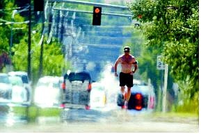 Brad Horn/Nevada Appeal Rob Robinson, of Carson City, runs up Fifth Street on Thursday afternoon. Temperatures continue to stretch in the high 90s and forecasters expect little change for the rest of the week.