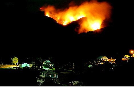 AP Photo Brad Horn/Nevada Appeal The Delaware fire on lights up Silver City on Thursday. The fire had burned about 220 acres in American Flat.