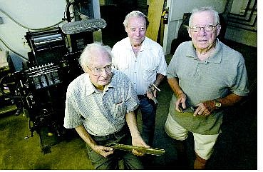 From left, Bill Dolan, Greg Krem and Sam Bauman combine for 169 years of journalism. They posed at Sierra Nevada Printing Friday afternoon in front of a more than 50-year-old Heidelberg press.   Cathleen Allison/Nevada Appeal