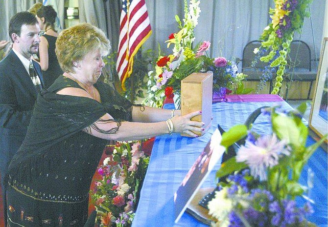 Cathleen Allison/Nevada AppealLinda Fettic, a family friend, sets up the ashes of Shelly Hachenberger before her memorial service Tuesday afternoon at the Brewery Arts Center.