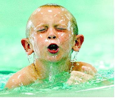 BRAD HORN/Nevada Appeal Joshua Keith, 8, of Carson City, competes in the swimming portion of the second annual Capital Kids Triathlon at Mills Park on Saturday.