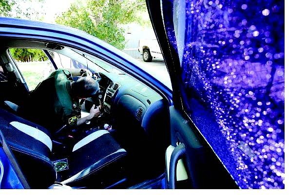Chad Lundquist/Nevada Appeal Carson City Sheriff&#039;s Deputy Brian Hardy searches the steering column of this Mazda Protege for the .22 cal. bullet that passed through its passenger window on Tuesday night. It was one in a string of shootings in the late-night and early morning hours.