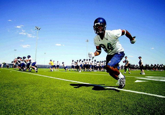 BRAD HORN/Nevada Appeal Nevada senior wide receiver Nichiren Flowers runs a play during the Wolf Pack&#039;s first practice on Friday.