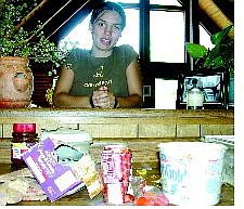 Cory McConnell/Nevada Appeal Tawnya McDowell poses in front of a fresh batch of groceries after what was most likely a bear broke into her house though a window and raided the kitchen.