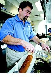 Jim Brenneis, owner of the Philadelphia Cheesesteak Co., works in his Basque Way kitchen on Monday.  Chad Lundquist Nevada Appeal