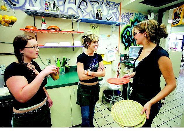 BRAD HORN/Nevada Appeal Java Dash owners Jennifer Dunn, right, and Kaysea Johnson, center, relax with employee Shawna Bollmann after a light lunch rush Thursday afternnon at the cafe located at Western Nevada Communtiy College. The three roomates work at the cafe and attend WNCC.