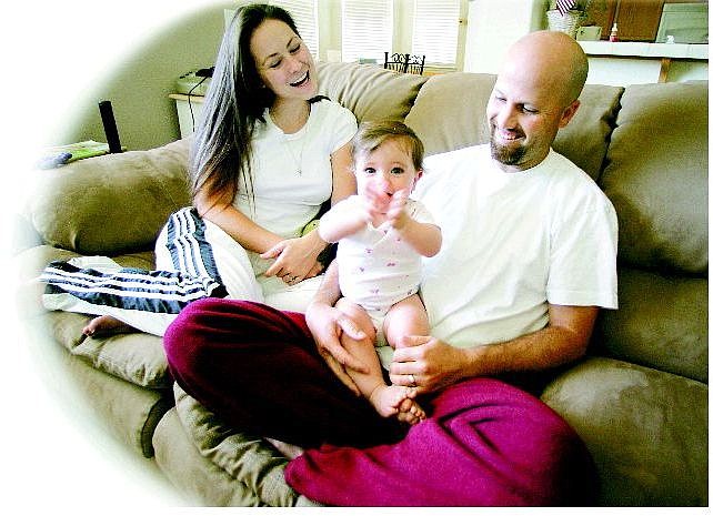 Mark Gardner, his wife, Katy, and their 10-month-old daughter, Kendra, sit in their Dayton living room Friday. Mark Gardner, a physical education teacher at Empire Elementary School, is recovering from the West Nile virus.  BRAD HORN/Nevada Appeal