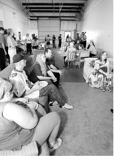 Chad Lundquist/Nevada Appeal Dee Dee Foremaster, top middle left, sits with volunteers and clients she has successfully helped at Tuesday&#039;s grand opening of the Do Drop In.