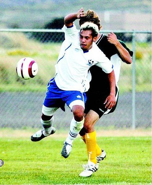 BRAD HORN/Nevada Appeal Carson Senator soccer captain Royal Good slips by a Manogue defender in the first half in Carson City on Wednesday.