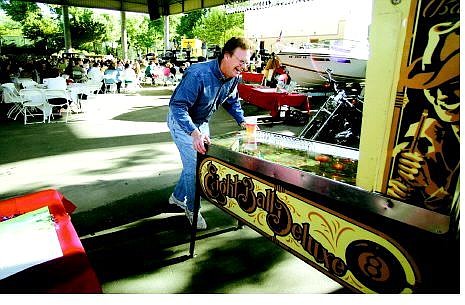 BRAD HORN/Nevada Appeal Conrad Buedel, of Minden, plays a pinball machine at the 12th annual Kids Auction and Worlds Greatest BBQ at the Pony Express Pavilion at Mills Park on Saturday. The proceeds raised benefit the Boys &amp; Girls Club of Western Nevada.