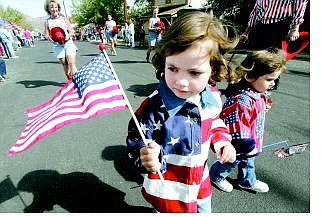 BRAD HORN/Nevada Appeal file Hannah Lewis, 4, front, and her sister Hailey, 3, of Dayton, entertain parade-goers with the Dayton Dukettes during the 2004 Dayton Valley Days parade.