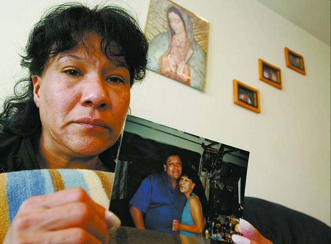 Brian Sokol/Nevada Appeal Marcela Fierro holds a photograph of her husband, Miguel Cruz, who was shot and killed in Spanish Springs on Saturday.
