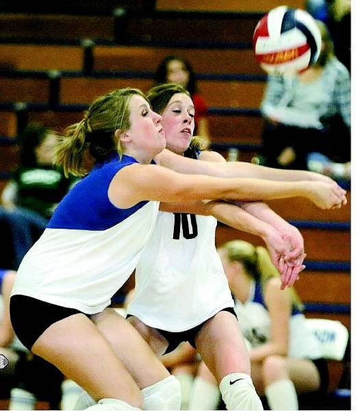 BRAD HORN/Nevada Appeal Carson Senators Michelle Raponi, left, and Morgan Nuckolls reach for a ball during their game against the Wooster Colts in Carson CIty on Thursday. The Senators beat the Colts 3-0.