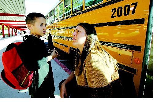 BRAD HORN/Nevada Appeal Melissa Bailey takes her son Donivan, 6, to talk to the bus drivers at Fritsch Elementary School to figure out how he got lost trying to get home Tuesday.