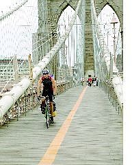 Rick Gunn pedals across the Brooklyn Bridge to finish the American leg of his bicycle journey around the world.