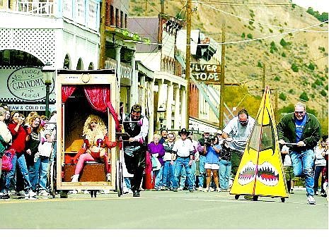 Brad Horn/Nevada Appeal The Ole Tyme Classic, left, and the Urinator race down C Street in Virginia City during the first heat of the 10th annual World Championship Outhouse Races on Saturday. Riding the Classic is Pammers Biddle of the Ole Tyme Saloon.