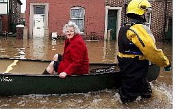 Associated Press An elderly resident is rescued by firefighters from floodwaters on Warwick Street in Carlisle, England, Sunday. Powerful winds and heavy rain swept across northern Europe overnight from Britain to Russia.