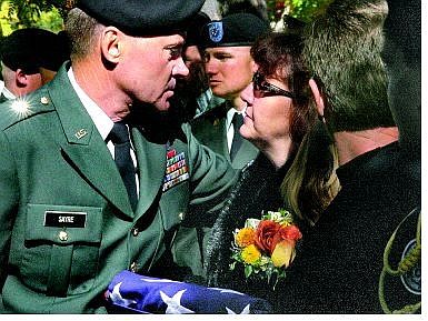 Steve Ranson/Nevada Appeal News Service Brig. Gen. Randall Sayre presents Roberta Stewart with the flag that was draped on her husband&#039;s coffin.