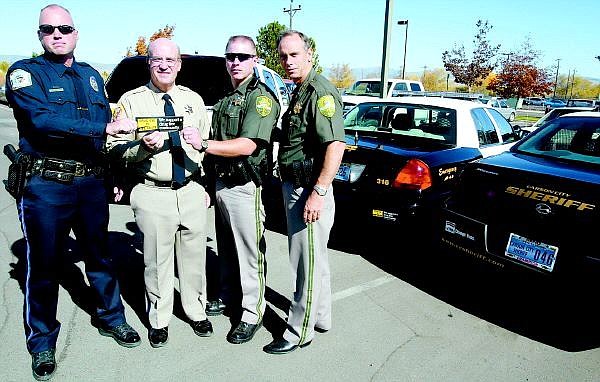 Shannon Litz/Nevada Appeal News Service J.C. Leonard of the Washoe Tribe of Nevada and California, Douglas County Sheriff Ron Pierini, Carson City Deputy Richard Batien and Carson City Sheriff Kenny Furlong with the bumper sticker &quot;Drug Use is Life Abuse.&quot;
