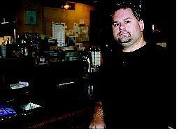 Chad Lundquist/Nevada Appeal Jason McKinney, owner of Scavos Karaoke Bar, stands in his new business on Wednesday.