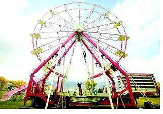 Carnival workers set up a Ferris wheel for a previous RSVP Nevada Day carnival at Mills Park  The annual carnival runs todayThursday through Sunday.