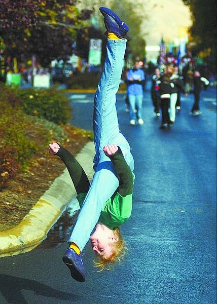 BRAD HORN/Nevada Appeal Tamara Holmes does a flip during the Nevada Day Parade on Saturday. Holmes works with Positive Energy gymnastics in Carson City.