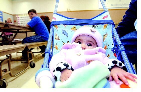Rick Gunn/Nevada Appeal Roxanna Cano, 7 months, sits with her sister Alejandra (not shown) during last year&#039;s Hispanic Community Information Night at Bordewich-Bray Elementary School.