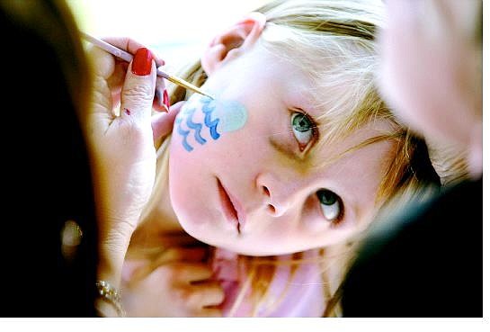 Cathleen Allison/Nevada Appeal Kaitrin Wilde, 6, gets a whale painted on her face during the All Saints Festival at St. Teresa of Avila school Tuesday afternoon. The student council put on the event to help students learn about the patron saints.