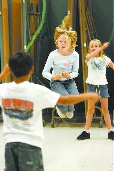 Cathleen Allison/Nevada Appeal Emily Edmundson jumps double-dutch as Kyle Sharp and Alison Barrette twirl the ropes during the Bordewich-Bray jump rope club.