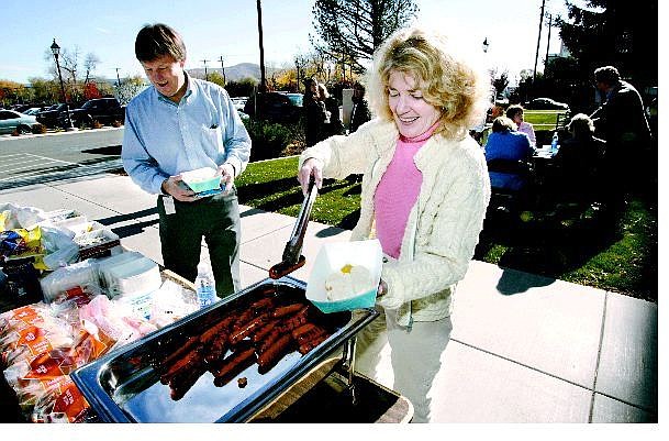 Cathleen Allison/Nevada Appeal State employees Layne Wilhelm, left, and Susan Mears serve up some lunch at a State of Nevada Employees Association hosted barbecue at the Kinkead Building on Thursday. State officials are applauding a decision from the Interim Finance Committee to move workers out of the building by next spring.