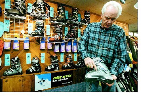 Curt Barnes, 77, of  Stagecoach owns the House of Ski on Kingsbury Grade. Here, he explains the finer points of a pair of flexible boots,  equipment he says is increasingly favored by older skiers.  Dan Thrift/ Appeal News Service