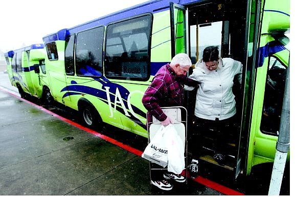 Chad Lundquist/Nevada Appeal Ray Soloninka, 79, helps his wife, Barbara, 64, step off of a JAC bus at the Plaza Street transfer station on Nov. 28. Officials say bad weather and no bus shelters are keeping ridership numbers down during the system&#039;s first paid month of operation.