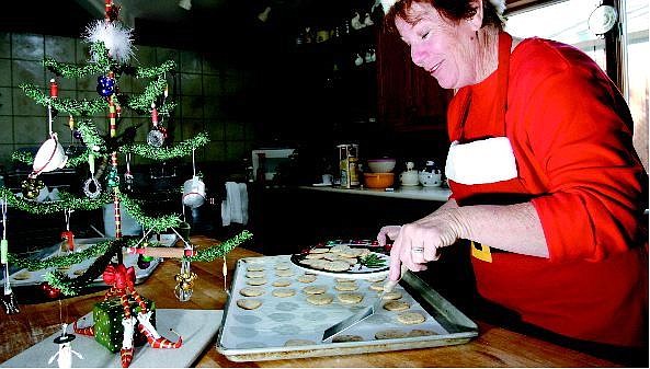 Chad Lundquist/Nevada Appeal Linda Marrone moves a freshly baked batch of cookies onto a plate at her home on Sunday. The Marrone home on Minnesota Street was built in 1883. The house is new to  this year&#039;s Victorian Home Christmas Tour.