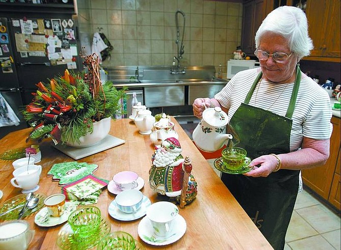 La-Tea-Da Tea Shoppe owner Rosemary Nebesky, 71, pours a cup of Christmas tea during the  Victorian Home Tour on Dec. 11.  Chad Lundquist/ Nevada Appeal