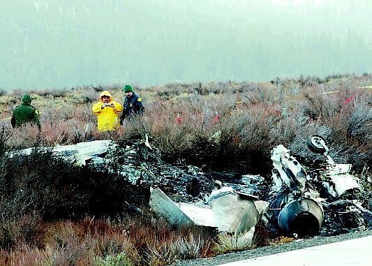 Photo by Ryan Salm/Sierra Sun Investigators examine remnants of the wreckage after a private jet crashed and burst into flames Wednesday. Both occupants were killed when the jet crashed as it tried to land at Truckee Tahoe Airport north of Lake Tahoe.