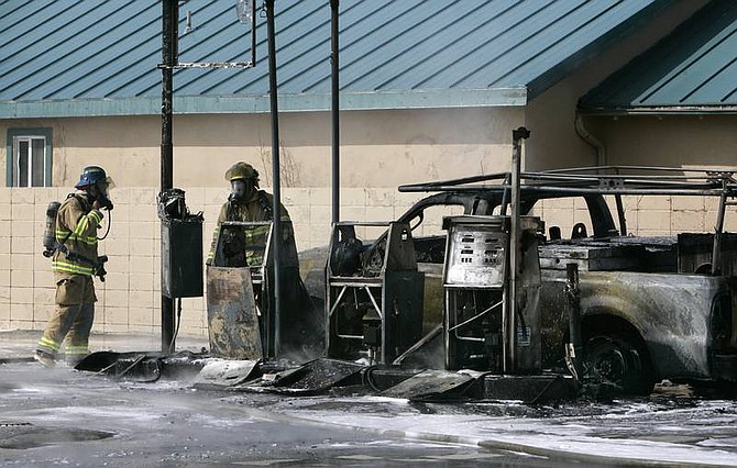 Cathleen Allison/Nevada AppealCarson City firefighters work to mop up a car fire at a North Carson fueling station.