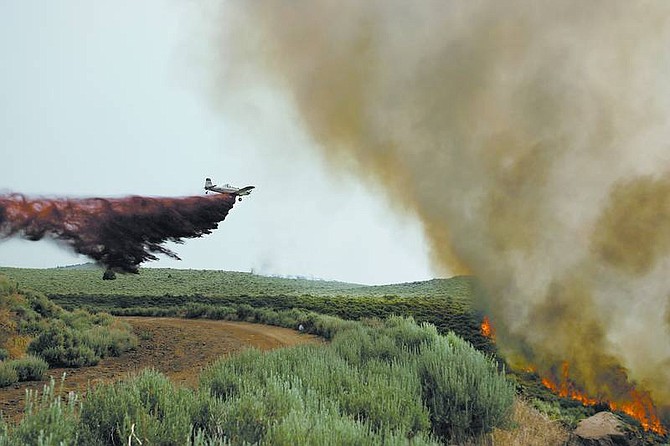 Cathleen Allison/Nevada AppealA single engine air tanker drops retardant on the Linehan fire at the top of Goni Canyon this afternoon.