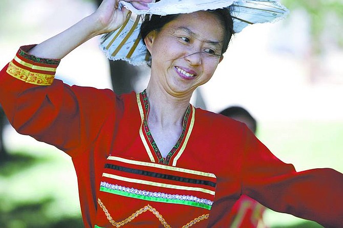 photos by Cathleen Allison/Nevada AppealSonia Carlson does a Chinese folding-hat dance during a presentation at the Silver City Park on Tuesday afternoon.