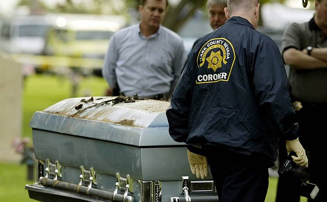 AP Photo/Isaac BrekkenA Clark County Coroner&#039;s Office medical examiner photographs the exhumed casket of Charles Augustine three years after his death at a cemetery in Las Vegas this morning. The Clark County coroner&#039;s office will perform an autopsy to determine if Augustine&#039;s cause of death is consistent with what is listed on his death certificate.