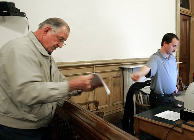 Chad Lundquist/Nevada AppealDistrict Attorney Harold Swafford, left, looks anxiously at the poll number printed out by Storey County IT Director James Deane, right, at the Storey County Courthouse Tuesday.  Swafford, received 962 votes to challenger Anne Langer&#039;s 887.
