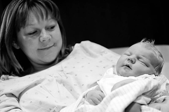 Chad Lundquist/Nevada Appeal Sandra Hughes holds her son, Michael Wayne, Sunday at Carson Tahoe Regional Medical Center. Nine-pound, 2-ounce Michael Wayne Hughes was born at 4:32 a.m., making him the first baby of 2006 at the hospital.