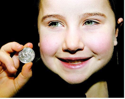 Associated Press Kate Krolicki, 7, the daughter of Nevada State Treasurer Brian Krolicki, holds the first Nevada State quarter that she helped strike during ceremonies at the Denver United States Mint on Thursday. The first commemorative quarter in 2006 honors Nevada and is the 36th coin in the U.S. Mint&#039;s 50 state quarter program.
