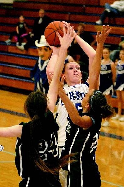 Kevin Clifford/Nevada Appeal Carson Senator Center Sarah Evans makes a shot while trying to be blocked by Devan Boundy (guard) and Stephany Pitts (Foward) from Damonte Ranch Mustang at Casron High School Tuesday, Jan. 10, 2006.
