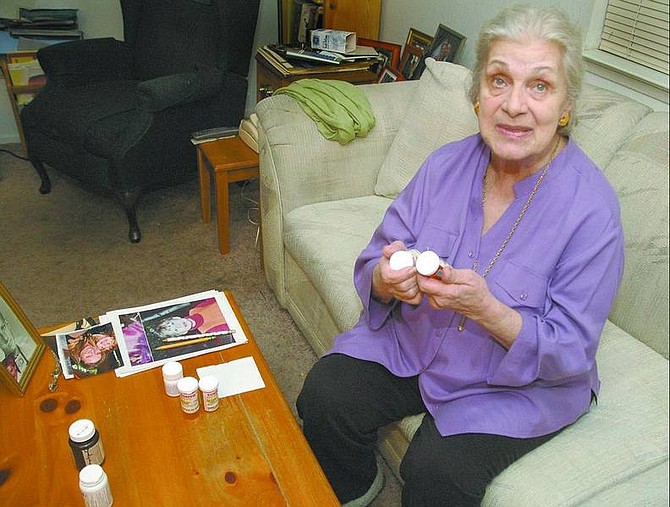 Kevin Clifford/Nevada Appeal Mabel Long, 81, holds some of her pill bottles as she explains the type of medication she&#039;s on at her home in Carson City Wednesday.  Long has been on prescription drugs for about 10 years and is currently on seven different medications.